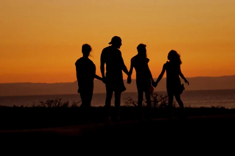Family members standing together at sunset reconnecting through Heights Mentoring family relationship work in Houston