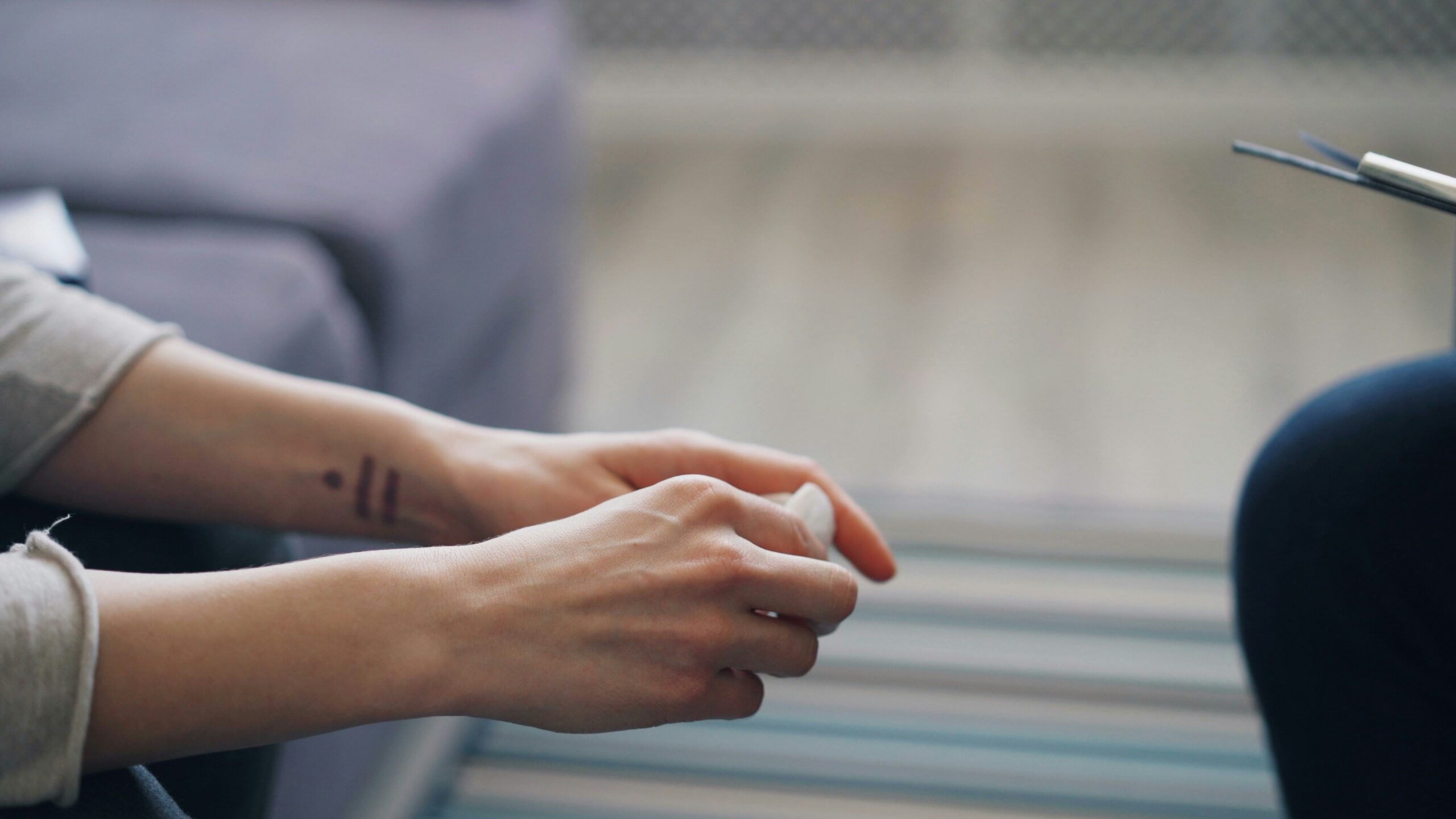 Person sitting alone after a therapy session, reflecting on what talking alone cannot fix