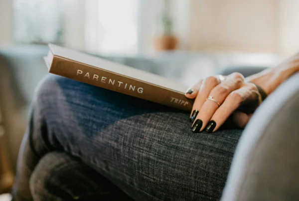 Parent and adult child talking at a kitchen table about boundaries and support
